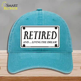 Retired And Living The Dream Novelty License Plate Hat Unconstructed Cotton / Lake Blue