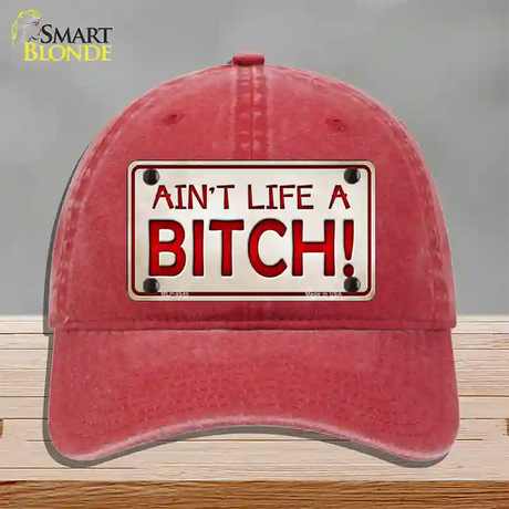 Aint Life A Bitch Novelty License Plate Hat Unconstructed Cotton / Red